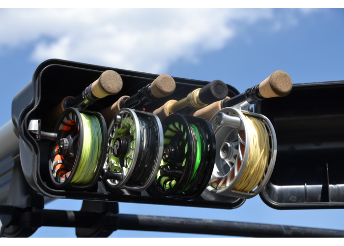 Close up of the open reel box of the river quiver. There are 4 reels of varying sizes inside with varying colors of line. The metal of this river quiver is silver. Behind the reel box is blue sky.